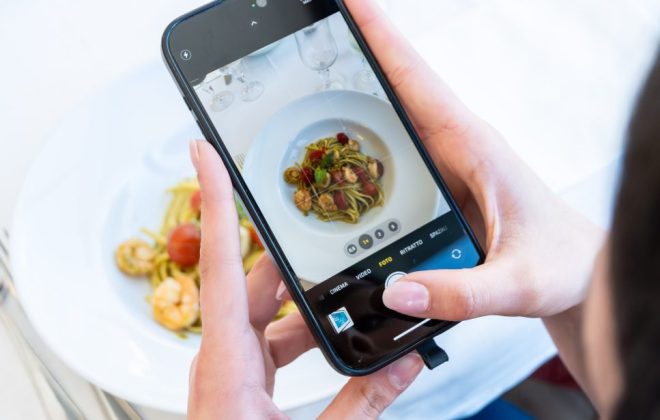 un cliente fotografa il suo piatto al pesce